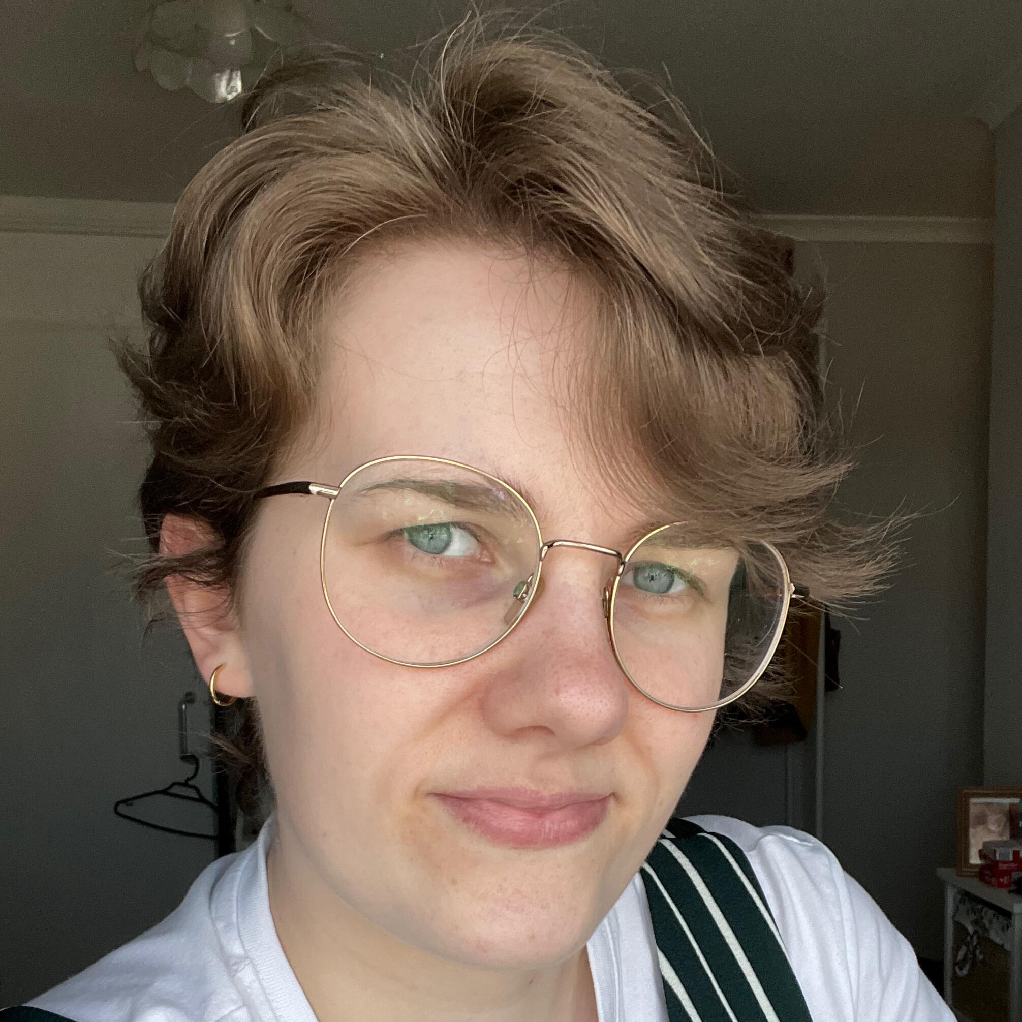 Line and Copy Editor of Speculative Fiction A photograph of me: short brunette hair, wearing glasses, and smiling at the camera.